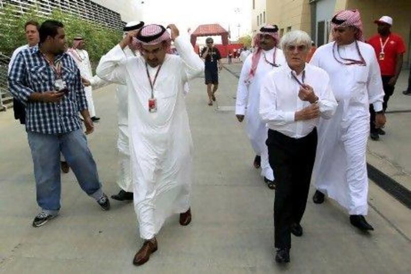 Sheikh Salman bin Hamad Al Khalifa, left, and Bernie Ecclestone in the paddock at the Bahrain International Circuit.