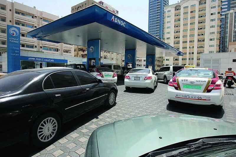 Cars queue at an Adnoc petrol station in Sharjah. Pawan Singh / The National