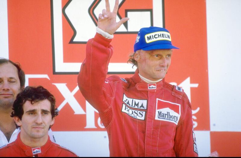 1984:  Marlboro McLaren drivers Alain Prost of France and Niki Lauda of Austria stand on the winners'' podium after the Portuguese Grand Prix at the Estoril circuit in Portugal. Prost finished in first place and Lauda in second. \ Mandatory Credit: Mike  Powell/Allsport