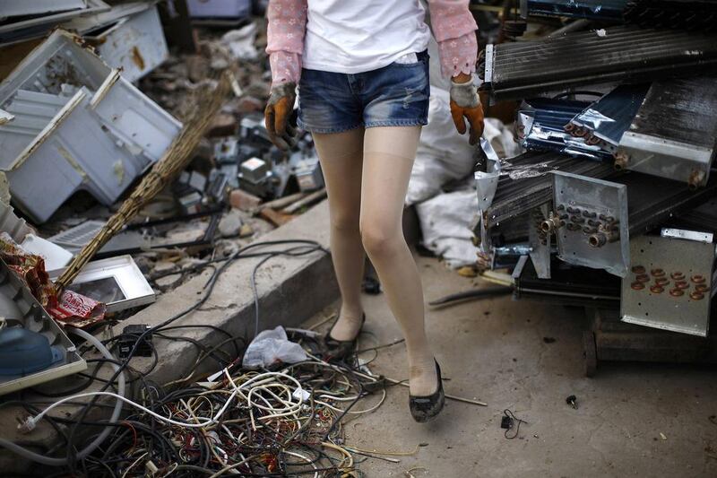 A recycling worker stands in the yard of a tenement house at Dongxiaokou village. Kim Kyung-Hoon / Reuters