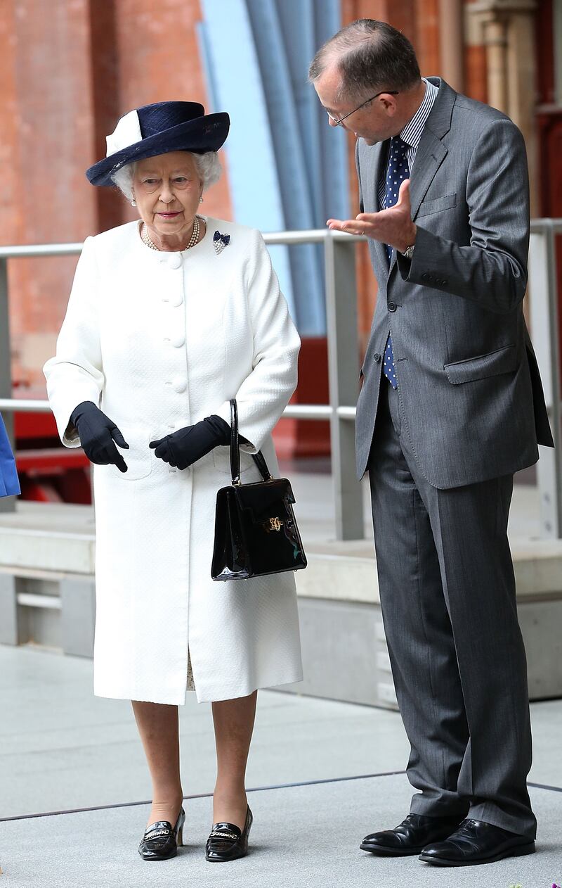 Queen Elizabeth II, wearing white, talks to Rob Holden, chairman of HS1, as she unveils a plaque at St Pancras International in London on June 5, 2014. Getty Images