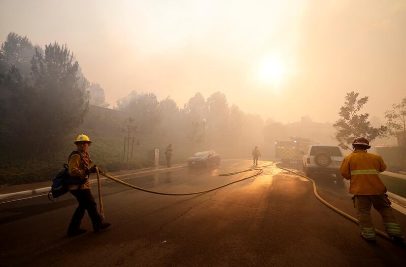 Firefighters gather as the Silverado Fire approaches, near Irvine, California, U.S. October 26, 2020. REUTERS