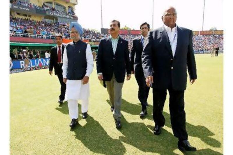 The prime ministers of India and Pakistan, Manmohan Singh, left, and Yousuf Raza Gilani, centre, walk the cricket pitch ahead of a match that many readers said had much more importance than mere sport. Daniel Berehulak / EPA