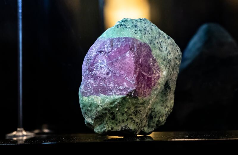 The gem has a variegated purplish-red hue and was mined in Winza, Tanzania.