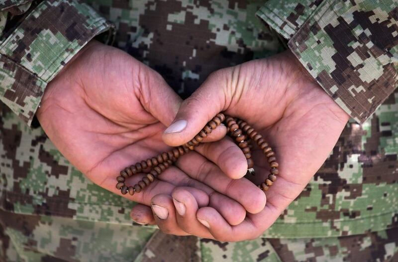 A soldier with the Afghan National Army (ANA) holds prayer beads during a basic training graduation ceremony at the ANA’s combined fielding centre. Scott Olson / Getty / March 18, 2014