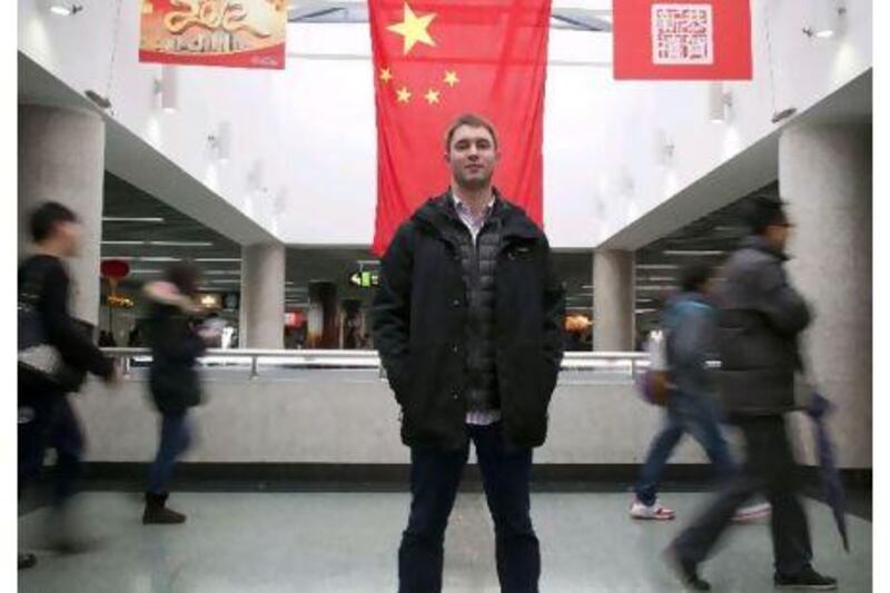 Ted Feierstein, 26, who works in Shanghai for a renewable energy company. Standing in the busy Peoples Square Underground station with passing-by Chinese. Jon Browning for The National