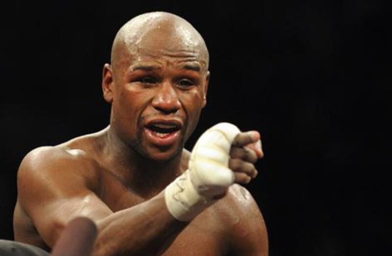 US boxer Floyd Mayweather gestures to the crowd after his super welterweight title bout against Puerto Rico's Miguel Cotto in Las Vegas, Nevada on May 5, 2012. Mayweather won the World Boxing Association super welterweight title with a unanimous points decision over Miguel Cotto on May 5 at the MGM Grand in Las Vegas. AFP PHOTO/Frederic J. BROWN