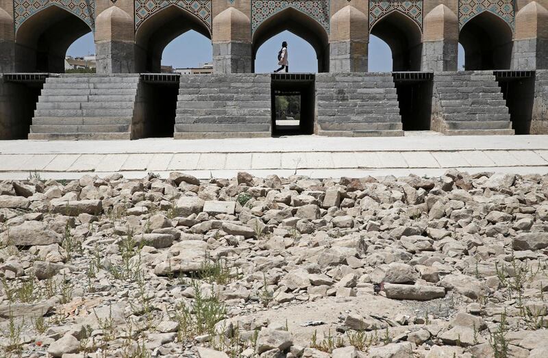 A woman walks on the Si-o-seh Pol bridge that now spans a dried up Zayandeh Roud river. AP Photo