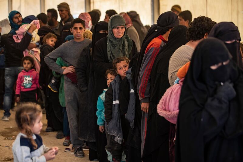 Syrians wait to leave the Kurdish-run al-Hol camp holding relatives of alleged Islamic State (IS) group fighters, in the al-Hasakeh governorate in northeastern Syria, on November 24, 2020. - A Kurdish official in charge of the region's camps, said 515 people from 120 families were returning to areas in the east of Deir Ezzor province, the first to do so after the Kurdish authorities in northeast Syria vowed to allow thousands of Syrians including the families of IS fighters out of the over-populated camp. (Photo by Delil SOULEIMAN / AFP)