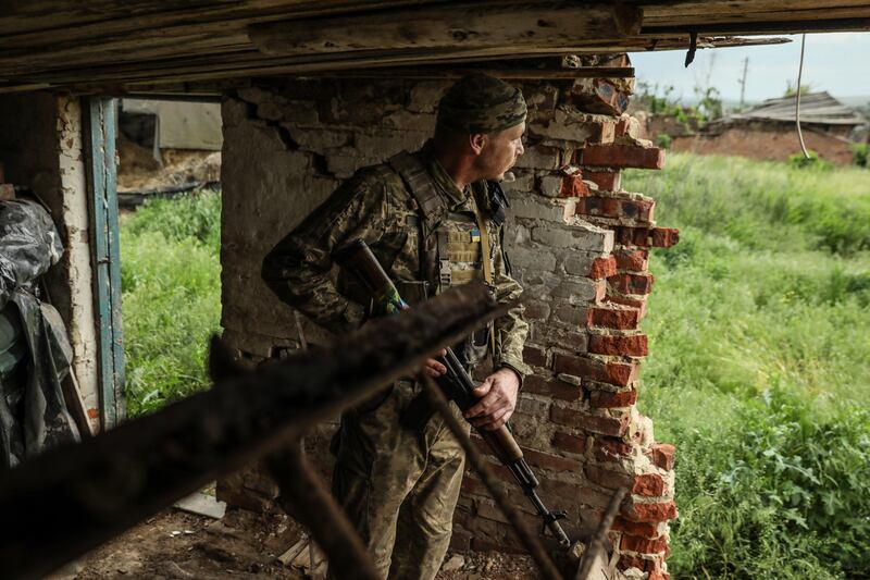 A Ukrainian serviceman from the 24th Separate Mechanised Brigade keeps watch on the front line. EPA