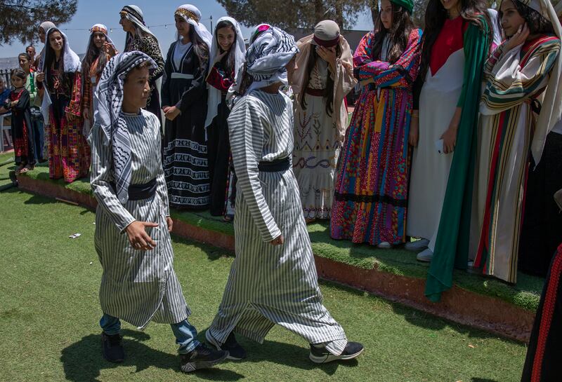 Two youths wearing traditional Palestinian costume on the opening day of the Beita market, in the West Bank village of Beita, near Nablus.  The Palestinian ministry of culture launched the first market of the Cultural Capital Markets programme, with others planned for ​the West Bank.