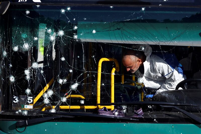 Israeli police inspect a damaged bus following an explosion at a bus stop in Jerusalem. Reuters