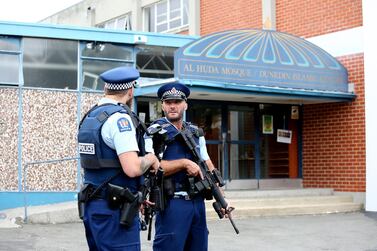Police look on as locals lay flowers and condolences at the Huda Mosque in tribute to those killed and injured at the Al Huda Mosque on March 16, 2019 in Dunedin. Getty