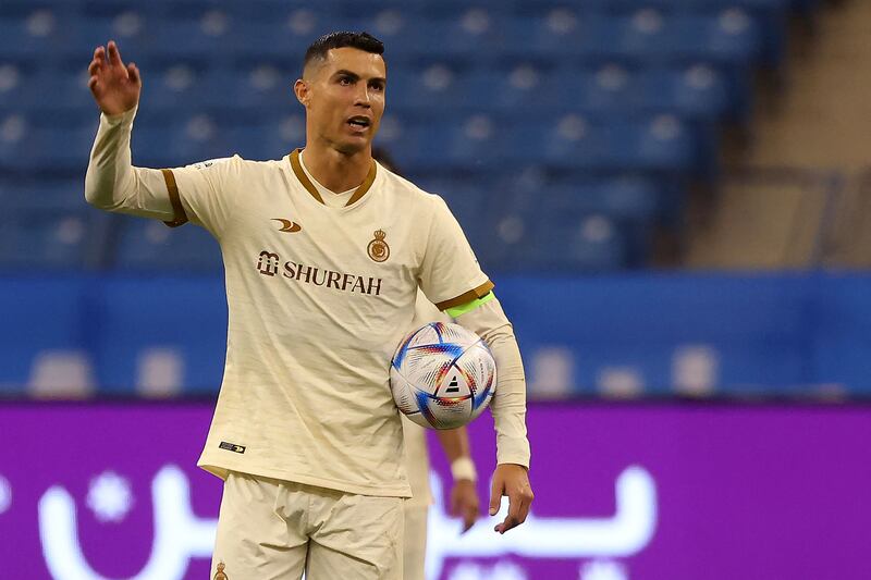 Cristiano Ronaldo holds the ball. AFP