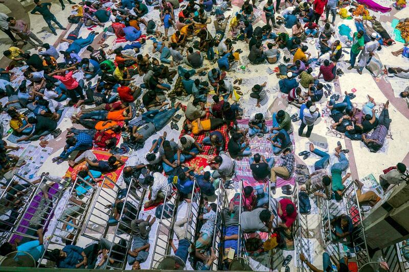 Bangladeshi people wait in a queue at the Kamalapur Railway Station as advance train tickets will begin in the morning after the counters open at 8:00am in Dhaka.  AFP