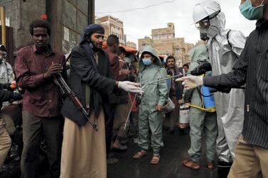 A health worker sprays people's hands at a market during a disinfection campaign in Sanaa, Yemen's rebel-held capital. The country's civil war has complicated efforts to counter the coronavirus pandemic. Getty