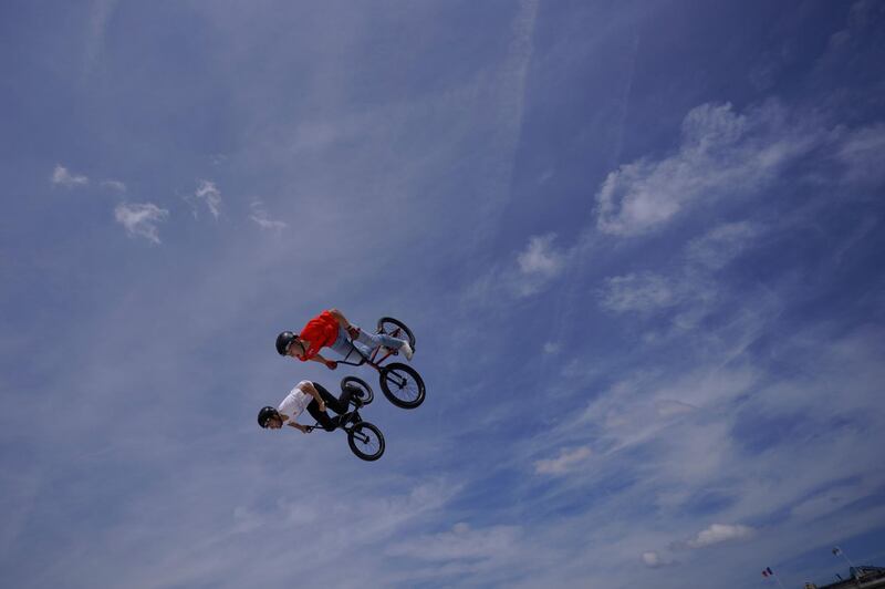 BMX riders perform in front of the Luxor Obelisk in Paris as he takes part in the "Journee Olympique" ("Olympic day".  AFP