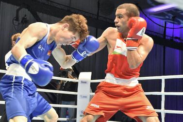 Amit Panghal ( red) lands a right jab on Kharkhuu Enkhmandakh in the Asian Boxing Championships at Le Meridien Grand Ballroom in Dubai on Wednesday, May 26, 2021. Courtesy BFI