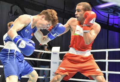 Amit Panghal (in red) lands a right jab on Kharkhuu Enkhmandakh in the Asian Boxing Championships at Le Meridien Grand Ballroom in Dubai on Wednesday, May 26, 2021. Courtesy BFI