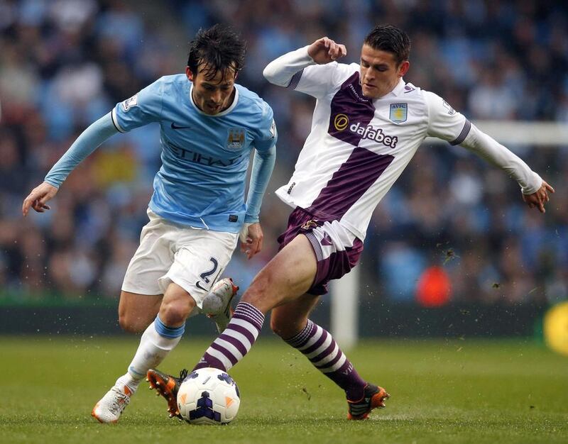 Manchester City midfielder David Silva challenges Aston Villa player Ashley Westwood during their Premier League match on Wednesday. Phil Noble / Reuters / May 7, 2014