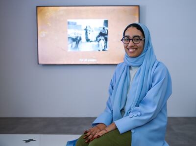 Fatema Al Fardan in front of her video - Then, a different breeze blew - for the 50 Years of Cool exhibition at MiZa in Abu Dhabi. Victor Besa / The National