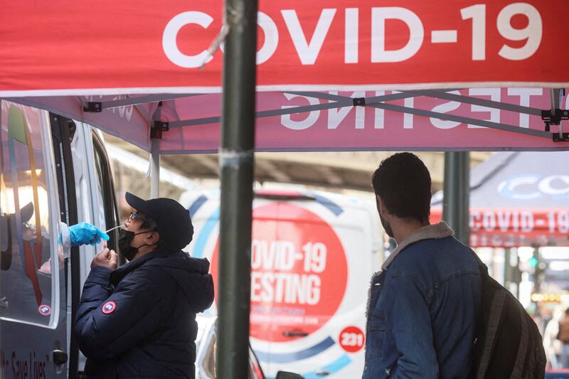 A man is given a Covid-19 test at a pop-up site on a pavement in New York City. Reuters