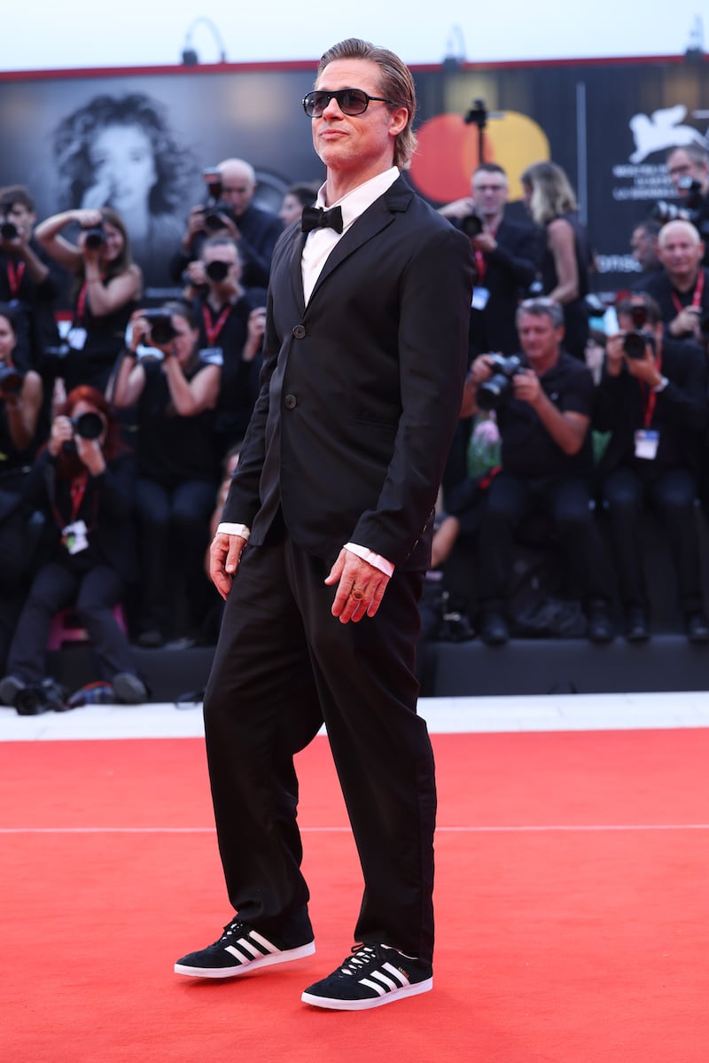 Brad Pitt, wearing a sharp tuxedo paired with adidas trainers, attends the 'Blonde' red carpet at the 79th Venice International Film Festival on September 8. Getty Images