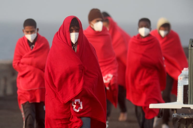 Migrants covered in blankets arrive at the port in Arrecife, Canary Islands, in February 2023, after being rescued at sea by Spanish authorities. EPA