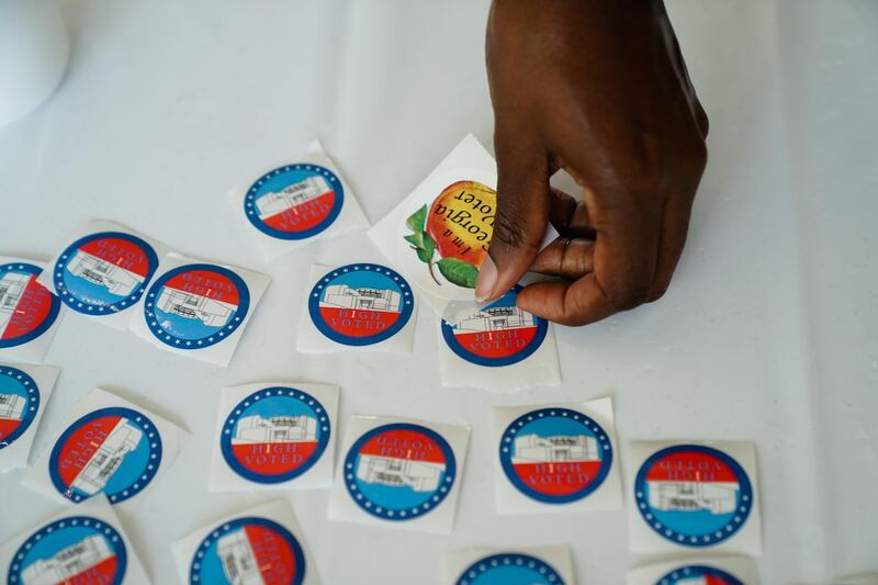 A resident takes a sticker after casting a ballot at an early voting polling location for the 2020 Presidential election in Atlanta, Georgia, U.S. Bloomberg