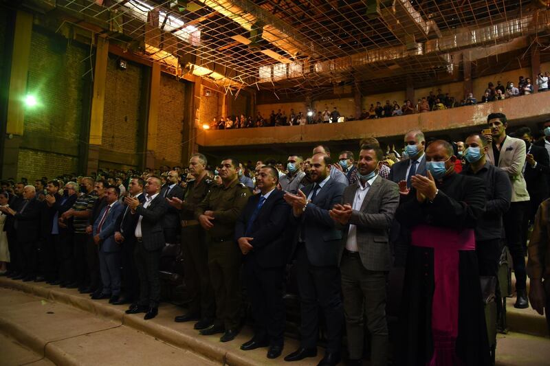 Iraqis give a standing ovation to the Watar orchestral ensemble after the concert at Mosul's Al Rabea Theatre on April 8, 2021. EPA