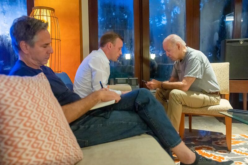 US President Joe Biden talks on the phone with Polish President Andrzej Duda as White House national security adviser Jake Sullivan, center, and Secretary of State Antony Blinken listen, in Bali, Indonesia. AP