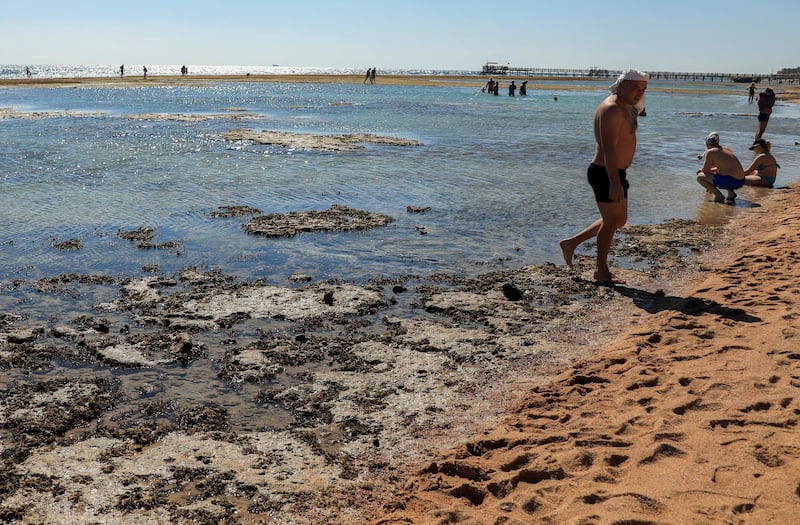 Tourists walk at the beach at low tide in the Red Sea resort of Sharm El-Sheikh, Egypt. Reuters