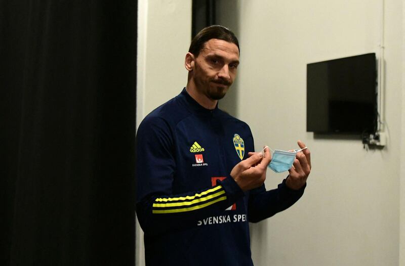 Zlatan Ibrahimovic puts on his face mask after a press conference on March 22, 2021 in Stockholm. AFP