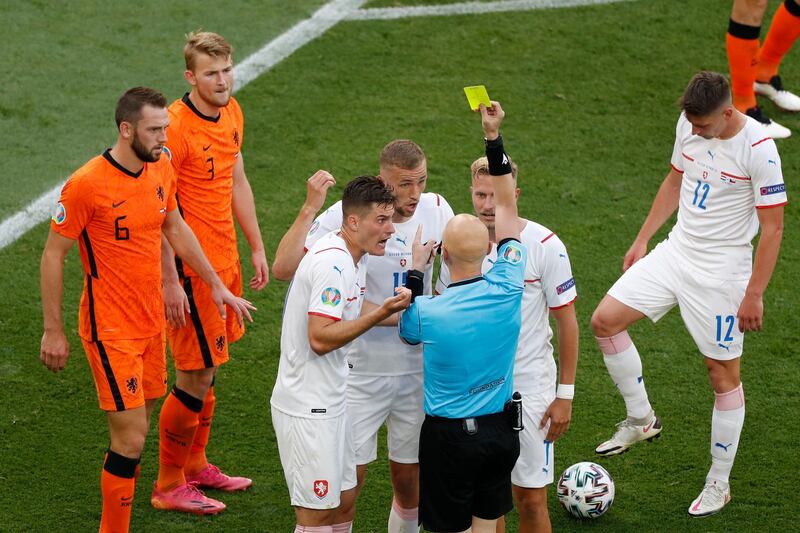 Russian referee Sergei Karasev shows a yellow card, that was then overturned to a red card, to Matthijs de Ligt. PA