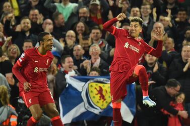 Liverpool's Roberto Firmino (R) celebrates after scoring the 3-1 goal during the UEFA Champions League quarter final, second leg soccer match between Liverpool FC and Benfica Lisbon in Liverpool, Britain, 13 April 2022.   EPA / PETER POWELL