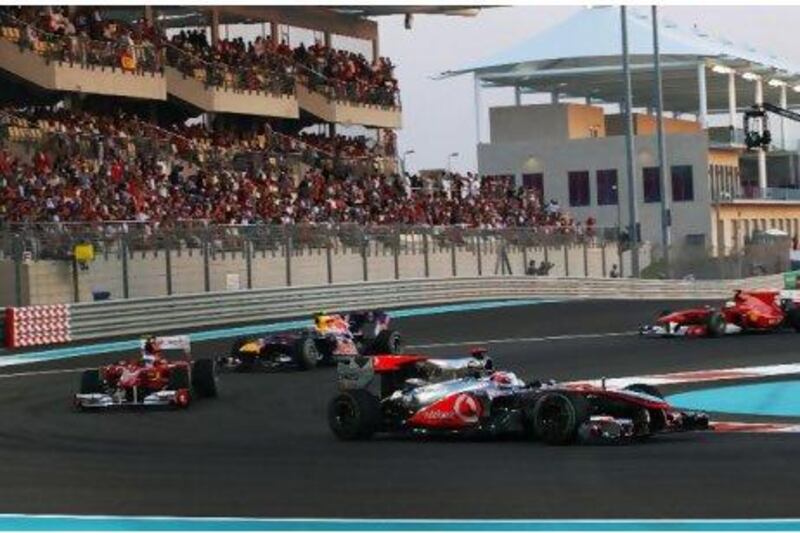 Jenson Button takes a turn at the Abu Dhabi Grand Prix last November. If an Emirati were on the track, you'd see more flags in the grandstand.