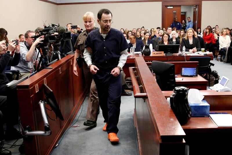 FILE PHOTO: Larry Nassar, a former team USA Gymnastics doctor who pleaded guilty in November 2017 to sexual assault charges, is escorted into the courtroom during his sentencing hearing in Lansing, Michigan, U.S., January 24, 2018. REUTERS/Brendan McDermid/File Photo