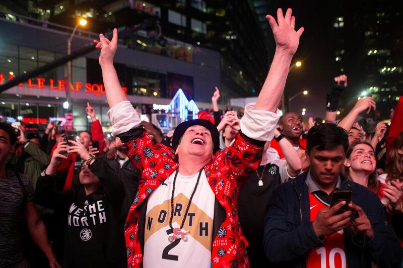 Toronto Raptors fans outside the arena celebrate in the closing seconds of the team's 100-94 win over the Milwaukee Bucks. AP Photo