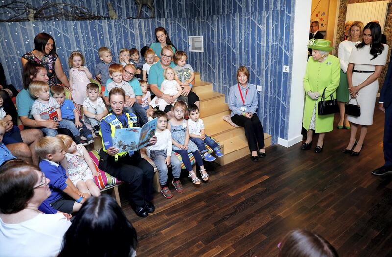 CHESTER, ENGLAND - JUNE 14:  Children look on as Queen Elizabeth II and Meghan, Duchess of Sussex arrive for their visit to the Storyhouse on June 14, 2018 in Chester, England. Meghan Markle married Prince Harry last month to become The Duchess of Sussex and this is her first engagement with the Queen. During the visit the pair will open a road bridge in Widnes and visit The Storyhouse and Town Hall in Chester.  (Photo by Phil Noble - WPA Pool/Getty Images)