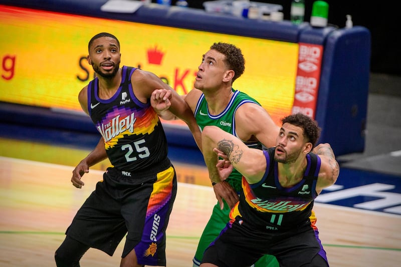 Abdel Nader and Phoenix Suns teammate Mikal Bridges compete for a rebound against Dallas Mavericks centre Dwight Powell. Reuters