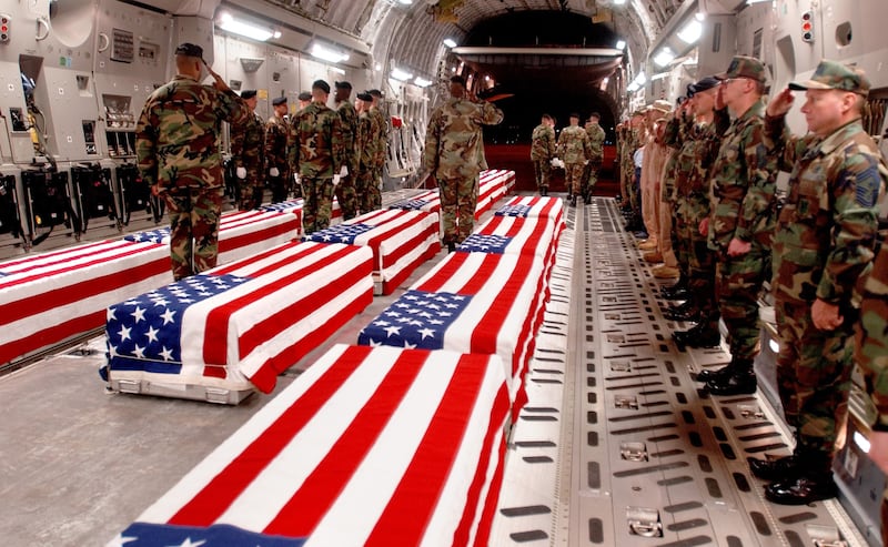 May 3, 2004: Coffins of US military personnel killed in Iraq are prepared to be offloaded at Dover Air Force Base in Delaware. Days later, Al Qaeda beheaded US businessman Nicholas Berg and recorded his killing. Reuters 