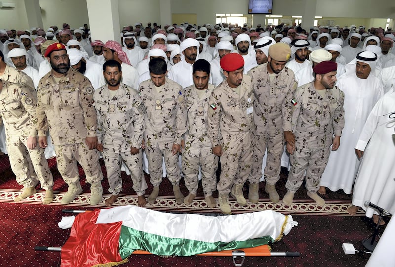 Men perform funeral prayers over the body of Warrant Officer Mohammed Saeed Al Hassani who was killed in a helicopter crash in Yemen. Wam