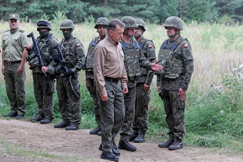 Polish Defence Minister Mariusz Blaszczak with troops at the Poland-Belarus border, where Warsaw plans to build a fence. EPA