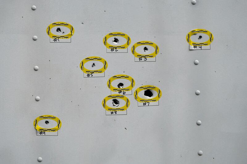Bullet holes on the side of a lorry are marked by police a day after a mass shooting in Philadelphia. Reuters