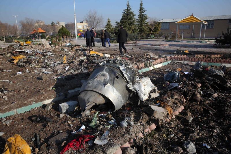 (FILES) In this file photo taken on January 8, 2020, rescue teams work amidst debris after a Ukrainian plane carrying 176 passengers crashed near Imam Khomeini airport in the Iranian capital Tehran early in the morning, killing everyone on board. The investigation into the tragedy of the Ukrainian Boeing shot down in January near Tehran has sparked diplomatic tensions between Iran and other countries. / AFP / -
