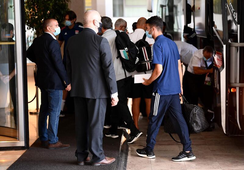 Lyon's French defender Leo Dubois, centre, arrives at the team hotel in Cascais ahead of the Champions League quarter-final against Manchester City. AFP