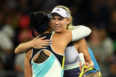 epa08143538 Caroline Wozniacki (R) of Denmark embraces Kristie Ahn of the USA (L) after winning their first round match at the Australian Open tennis tournament at Melbourne Arena in Melbourne, Australia, 20 January 2020.  EPA/LUKAS COCH EDITORIAL USE ONLY AUSTRALIA AND NEW ZEALAND OUT