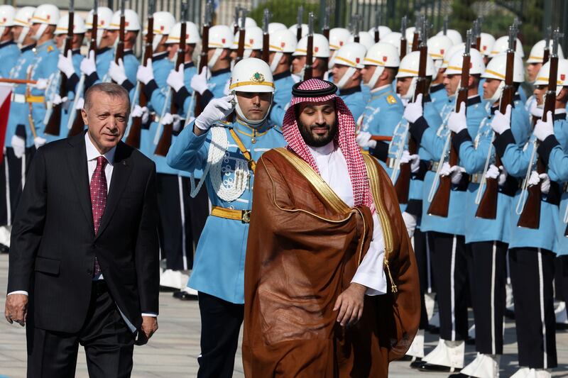 Mr Erdogan and Prince Mohammed review a guard of honour during a welcoming ceremony at the Presidential Complex. Reuters