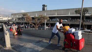 People push luggage outside Beirut international airport. Many countries have urged their citizens to leave Lebanon. Reuters