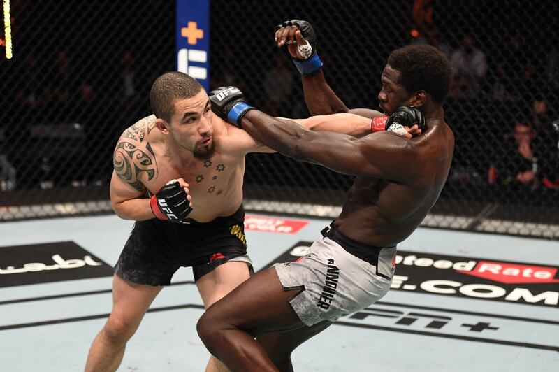 Robert Whittaker punches Jared Cannonier. Getty